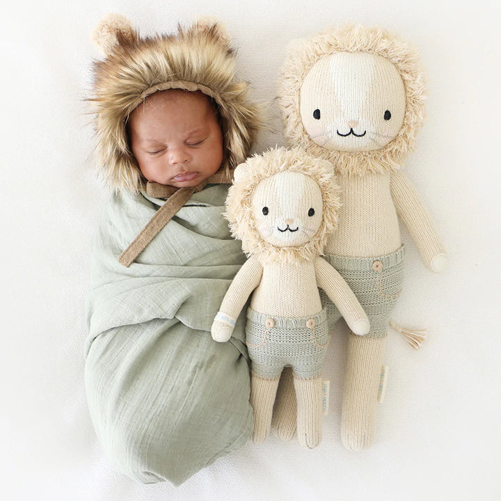 baby using a sage swadlle  with Cuddle and kind dolls